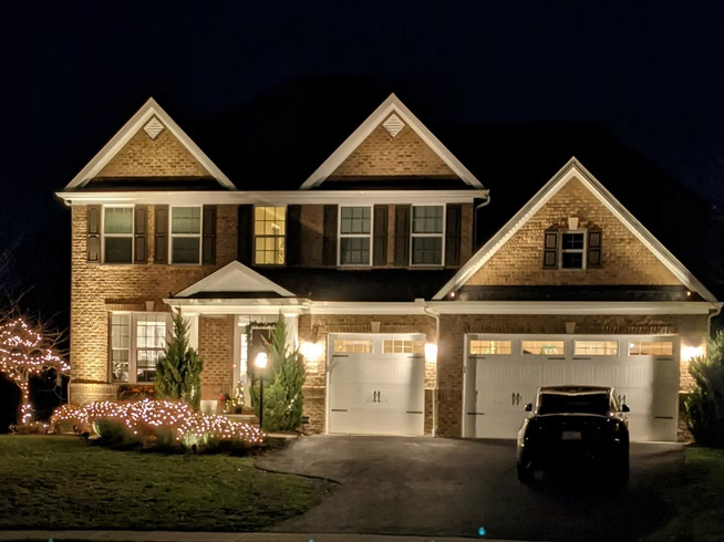 Pittsburgh home with landscape and holiday lighting at night